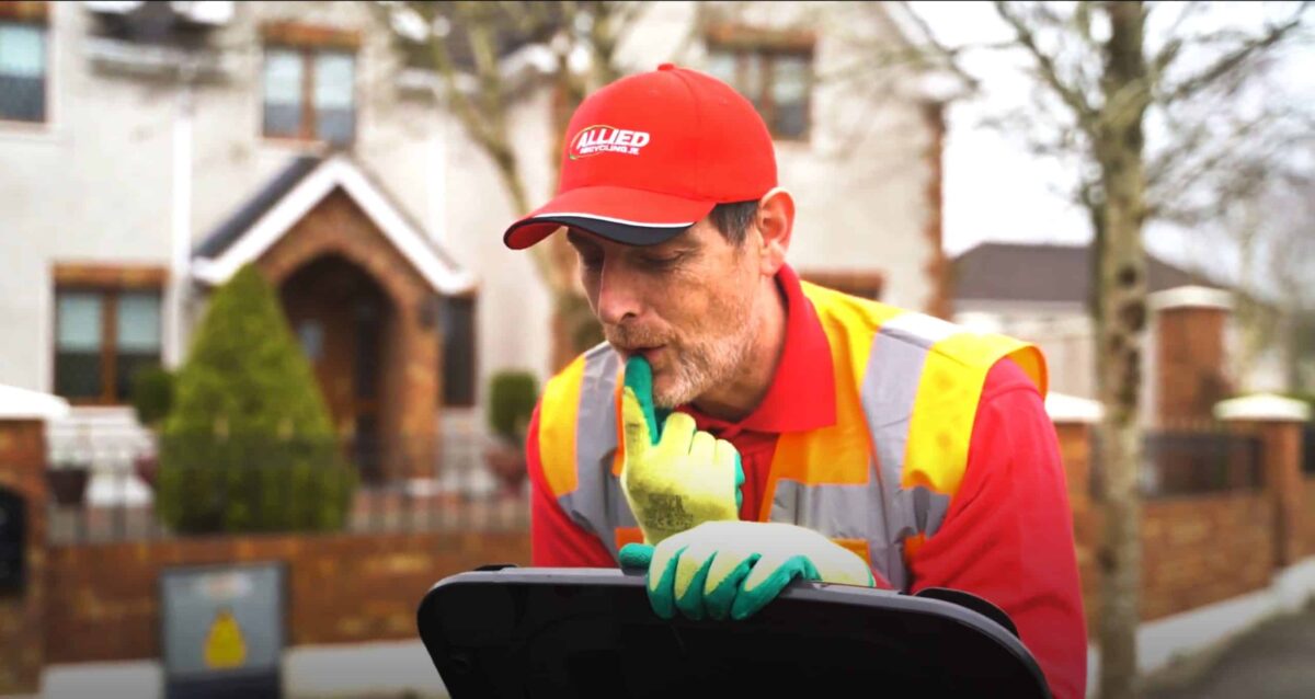 bin man looking in a black domestic bin