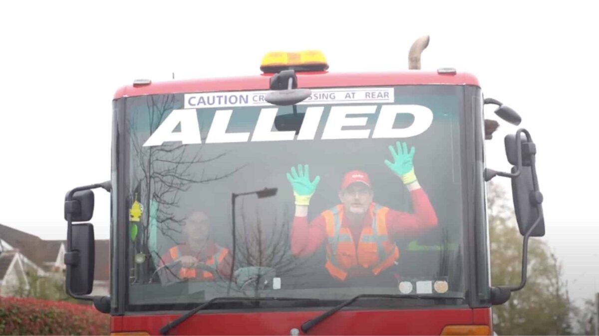 Two men inside a bin lorry